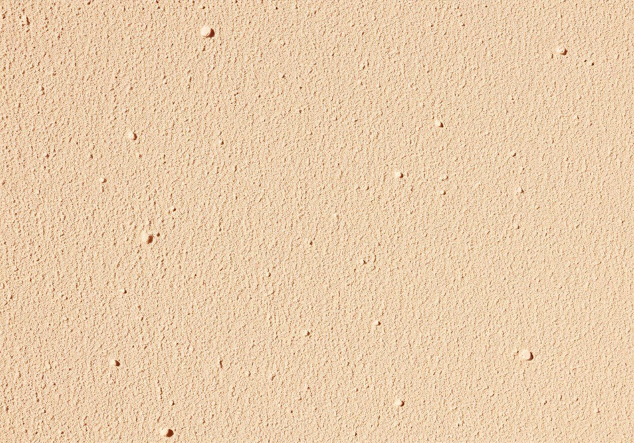 Close-up textured stucco wall surface